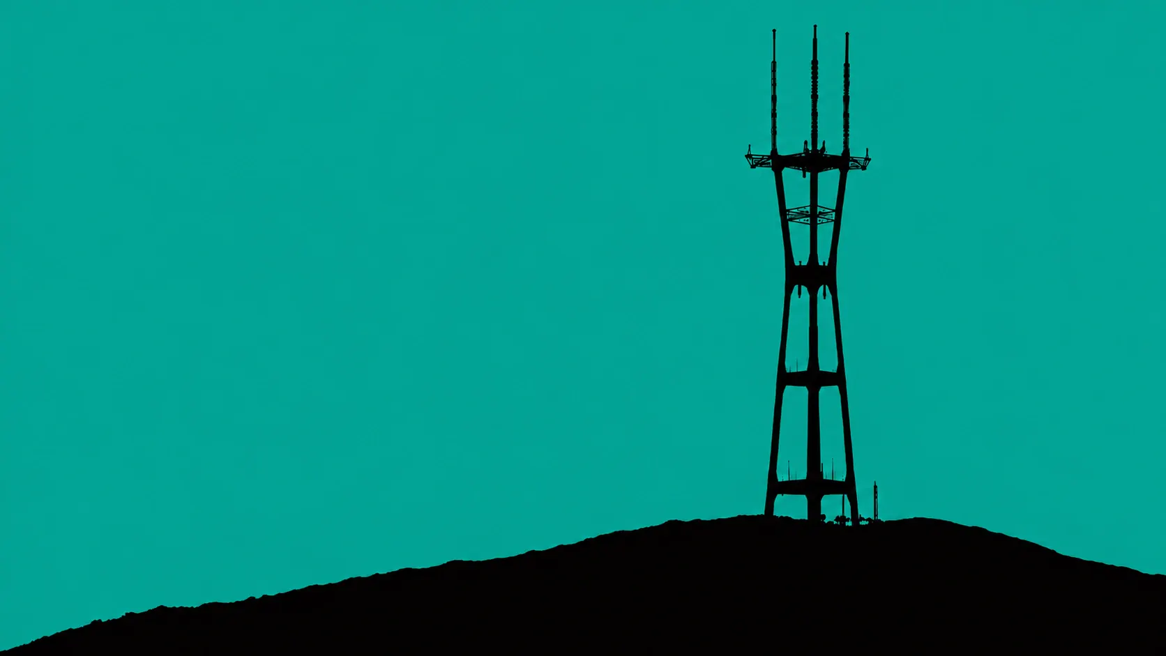 Sutro Tower silhouetted against a teal sky.